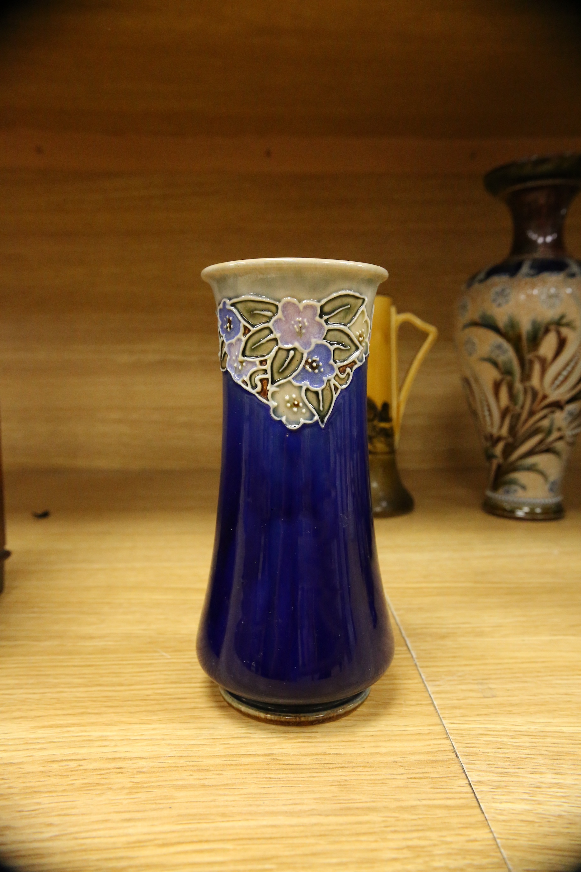 Four Royal Doulton vases and a yellow glazed jug items, tallest vase 34cm high. Condition - some crazing and faults, large vase has damage to lower neck